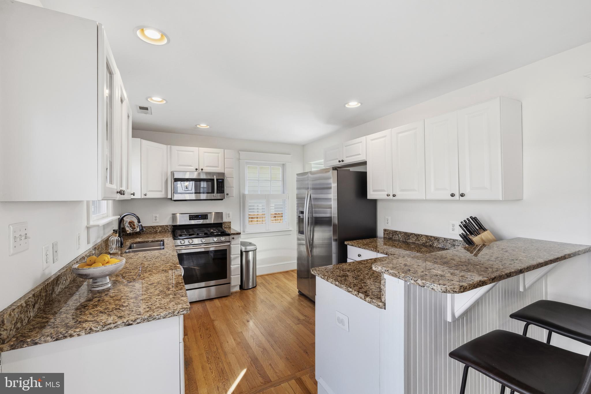 304 Locust Avenue Annapolis, MD 21401 - Photo 6 of 58 a kitchen with granite countertop stainless steel appliances a sink a stove a refrigerator cabinets and a counter top space