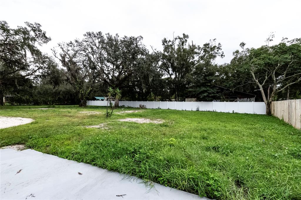 1550 South Tanner Road Orlando, FL 32833 - Photo 5 of 9 a view of green field with trees in the background