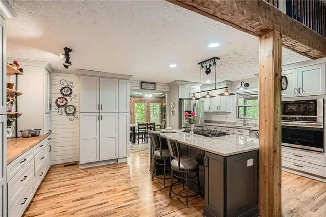 a kitchen with a stove and a wooden floor