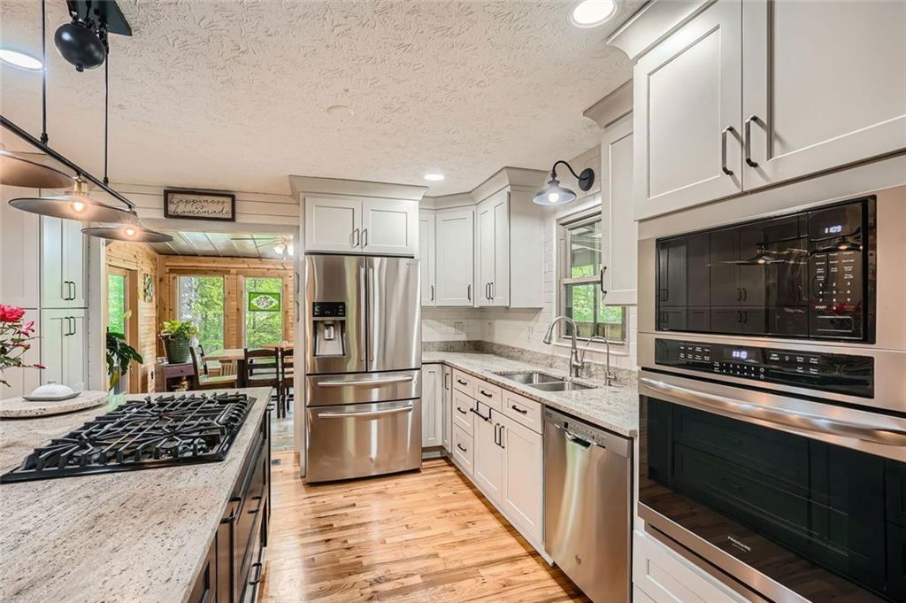 5419 Tyree Road Winston, GA 30187 - Photo 27 of 77 a kitchen with stainless steel appliances granite countertop a stove and a refrigerator