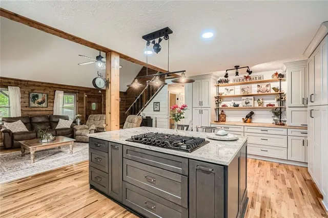 a spacious bedroom with a bed and a chandelier