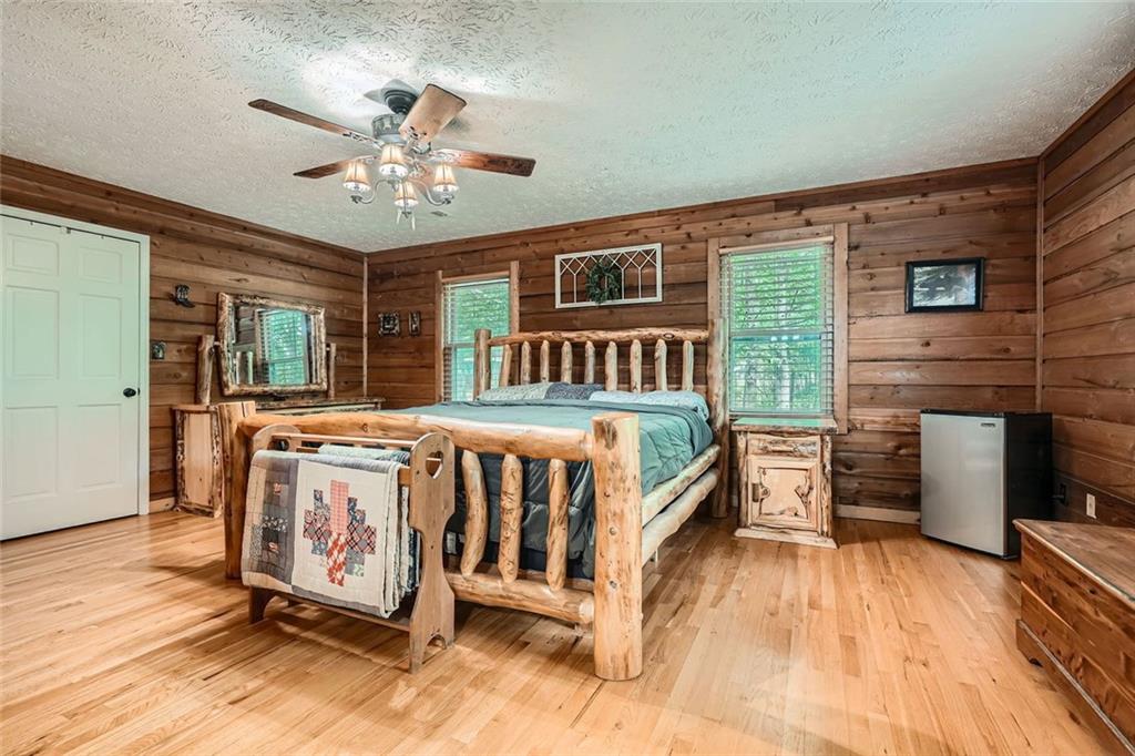 5419 Tyree Road Winston, GA 30187 - Photo 34 of 77 a spacious bedroom with a bed and a chandelier