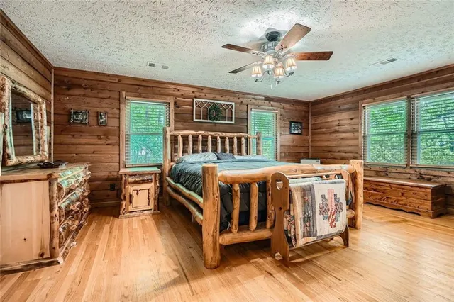 a bedroom with a bed and a painting on the wall