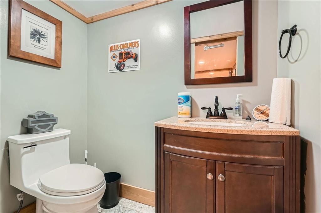 5419 Tyree Road Winston, GA 30187 - Photo 42 of 77 a bathroom with a toilet a sink and mirror