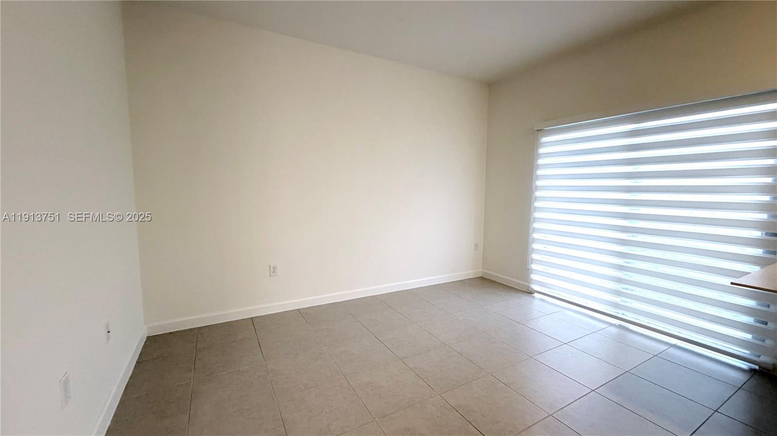 23250 Southwest 133rd Court Homestead, FL 33032 - Photo 11 of 31 an empty room with a window
