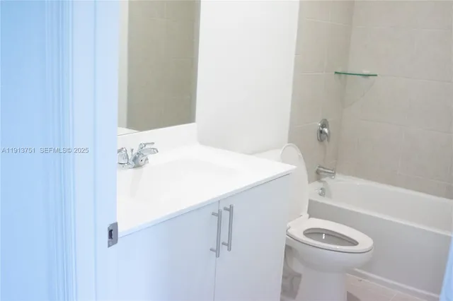 a bathroom with a sink a toilet and bathtub