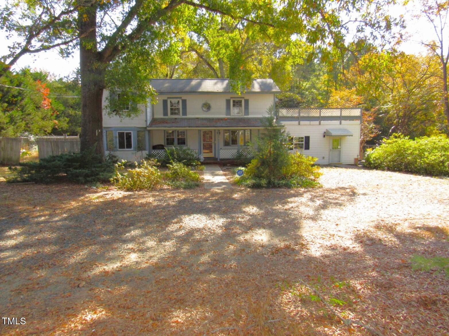 3518 Cheek Road Durham, NC 27704 - Photo 1 of 38 a front view of a house with a yard and trees