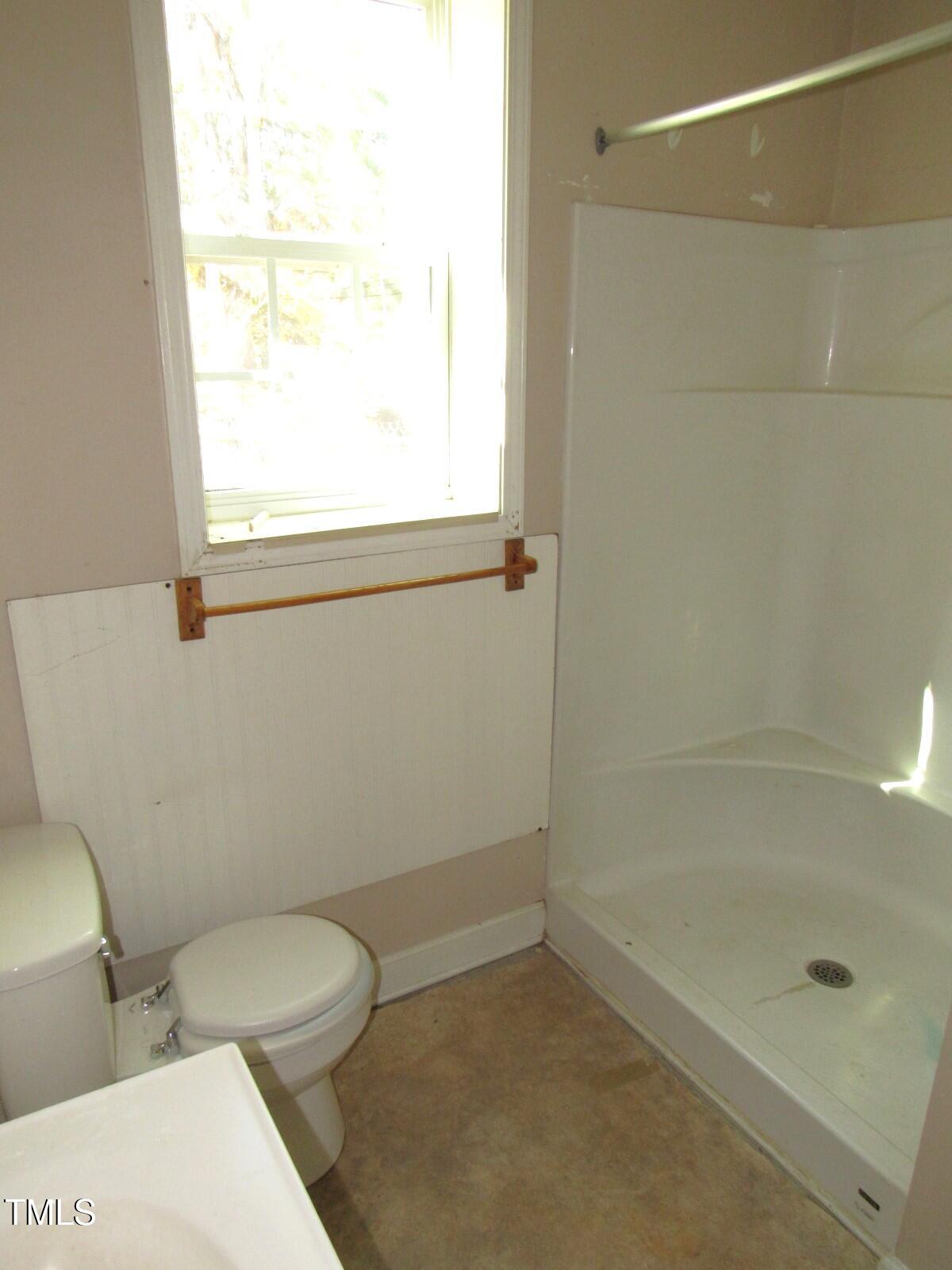 3518 Cheek Road Durham, NC 27704 - Photo 11 of 38 a bathroom with a toilet and a shower