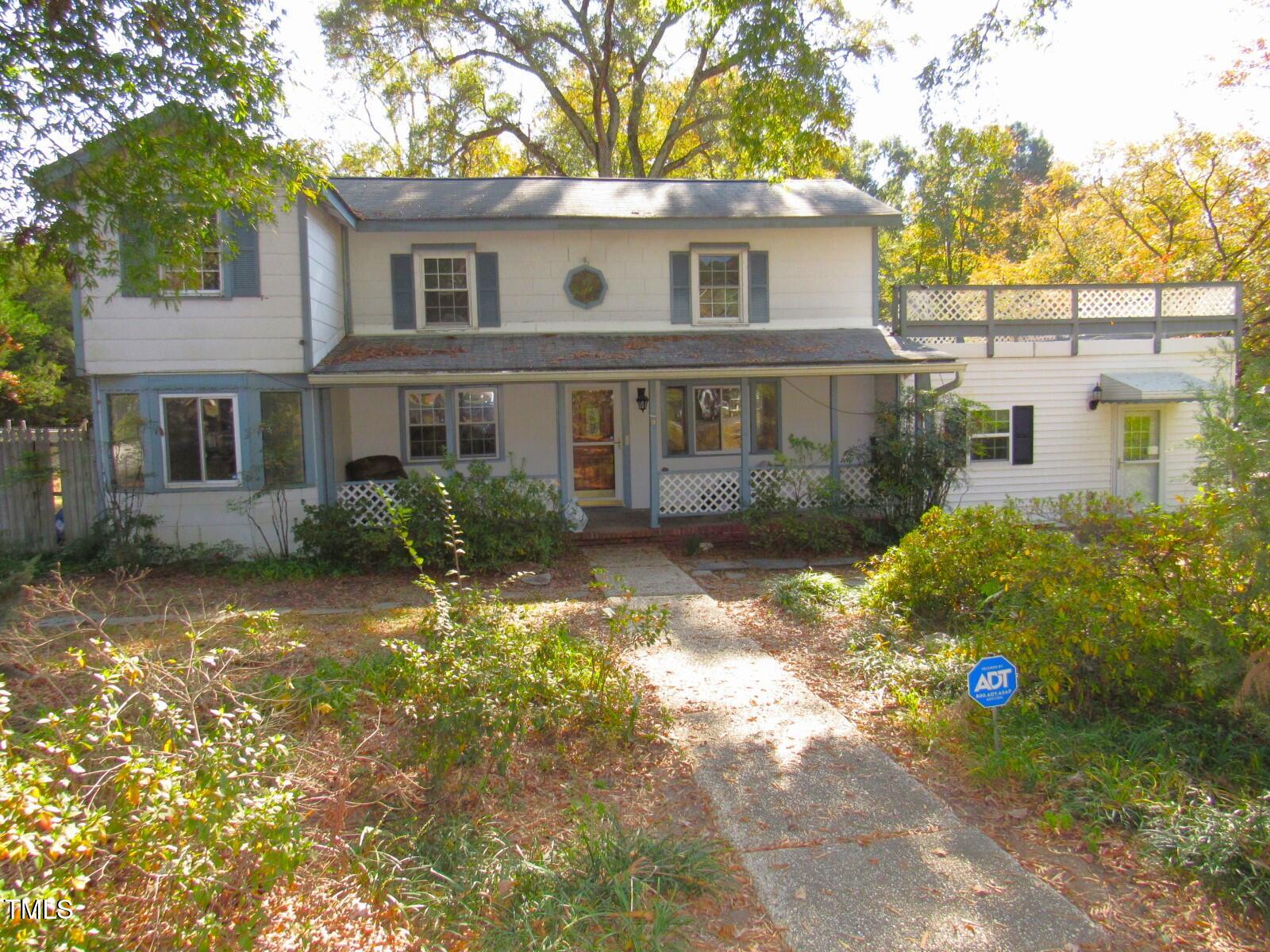 3518 Cheek Road Durham, NC 27704 - Photo 32 of 38 a front view of a house with a yard and garage