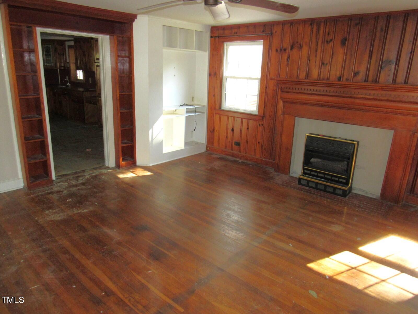 3518 Cheek Road Durham, NC 27704 - Photo 4 of 38 an empty room with windows and fireplace
