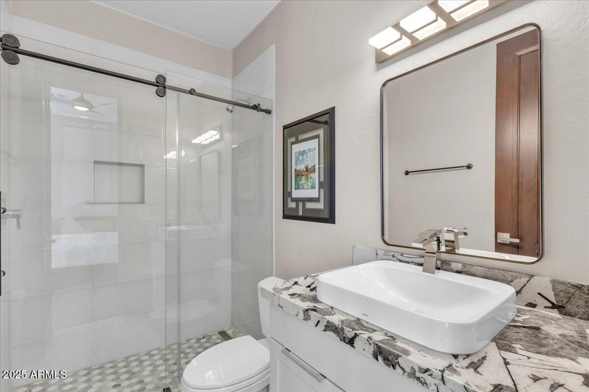 10040 East Happy Valley Road, Unit 300 Scottsdale, AZ 85255 - Photo 37 of 92 a bathroom with a sink toilet tub and shower