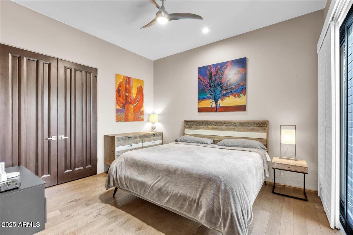 10040 East Happy Valley Road, Unit 300 Scottsdale, AZ 85255 - Photo 40 of 92 a bedroom with a bed and a painting on the wall