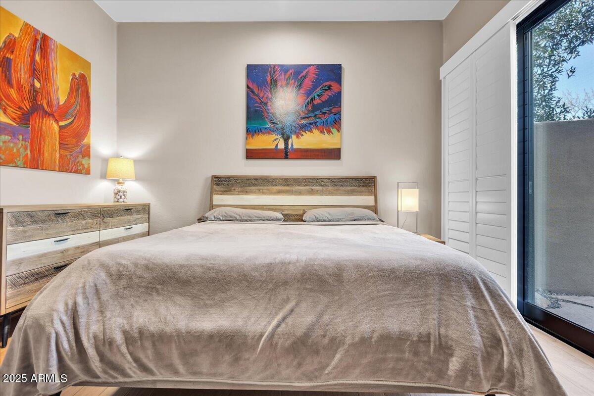 10040 East Happy Valley Road, Unit 300 Scottsdale, AZ 85255 - Photo 41 of 92 a bedroom with a bed and a painting on the wall