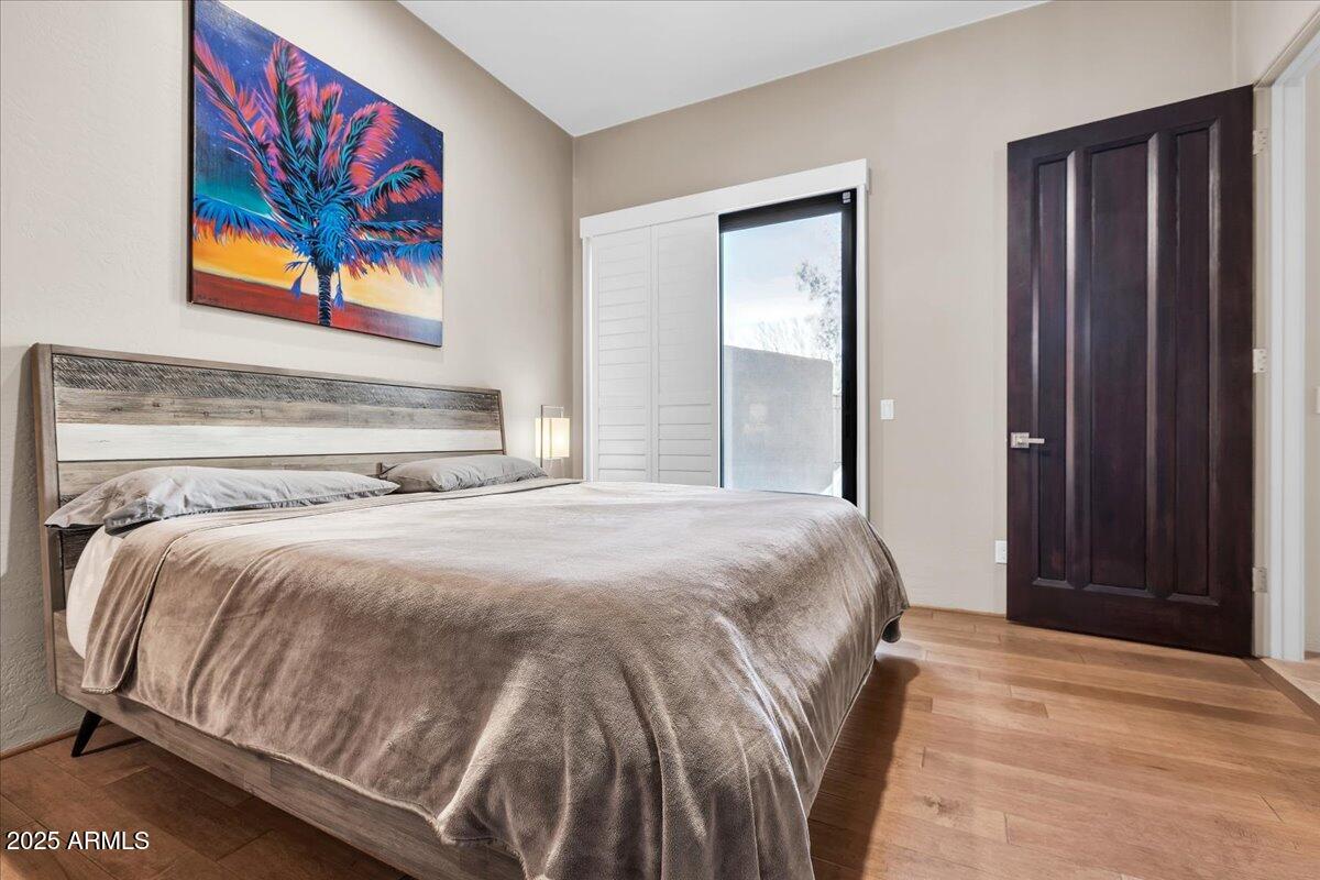 10040 East Happy Valley Road, Unit 300 Scottsdale, AZ 85255 - Photo 42 of 92 a bedroom with a bed and painting on the wall