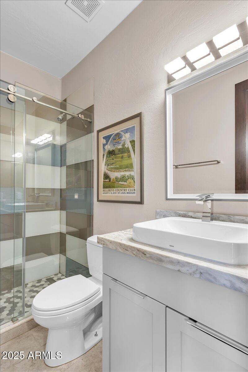 10040 East Happy Valley Road, Unit 300 Scottsdale, AZ 85255 - Photo 43 of 92 a bathroom with a sink a toilet and shower