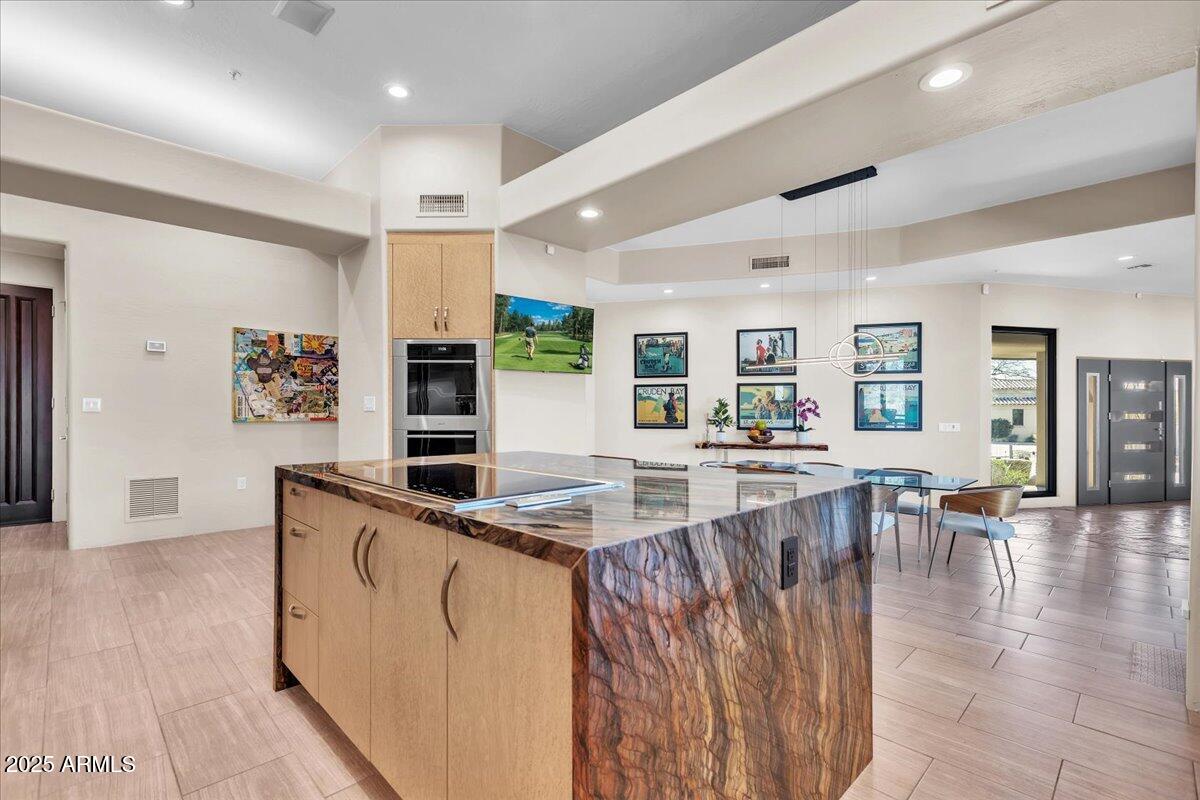 10040 East Happy Valley Road, Unit 300 Scottsdale, AZ 85255 - Photo 6 of 92 a large kitchen with stainless steel appliances kitchen island granite countertop a large counter top and breakfast area