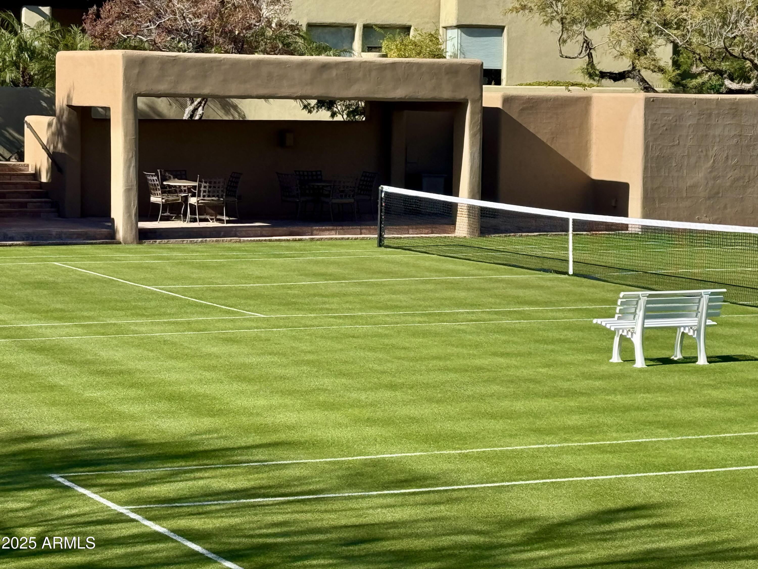 10040 East Happy Valley Road, Unit 300 Scottsdale, AZ 85255 - Photo 89 of 92 a view of a chairs and table on the green field