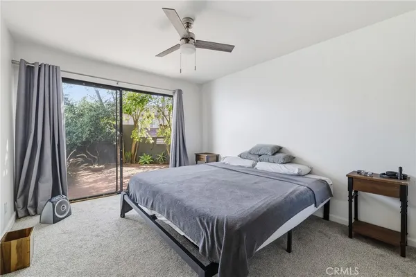 a bed sitting in a bedroom next to a window