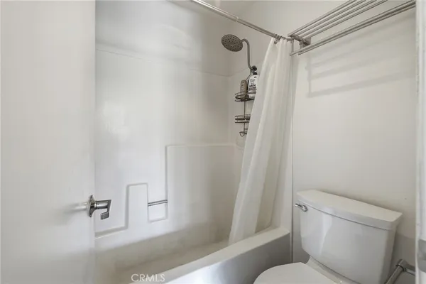 a bathroom with a shower and a toilet