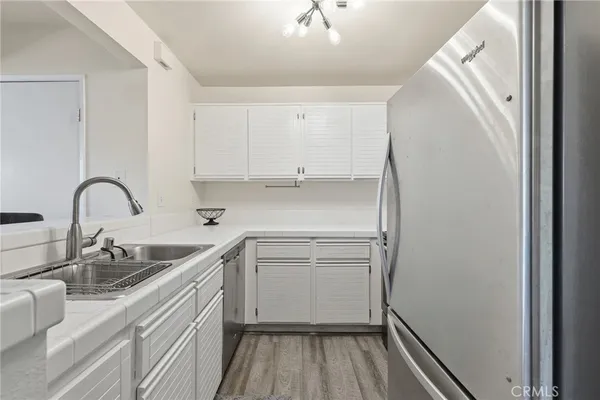 a kitchen with a sink and a refrigerator