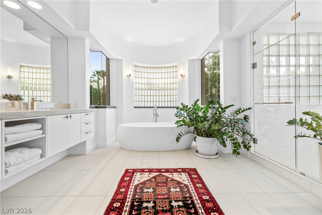 2000 Grouse Street Las Vegas, NV 89134 - Photo 46 of 89 An oasis of tranquility, this primary bathroom boasts a freestanding tub and a spacious glass-enclosed shower.