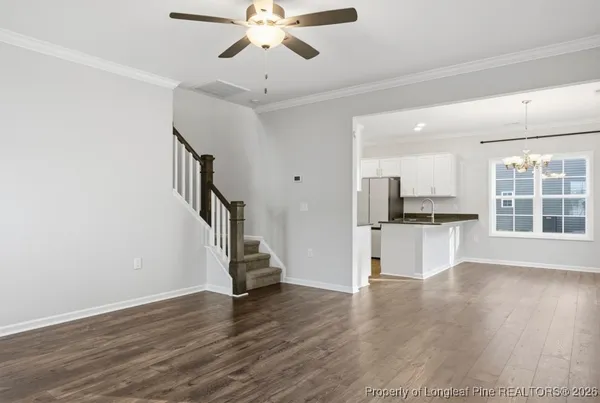 a view of kitchen with refrigerator microwave and wooden floor
