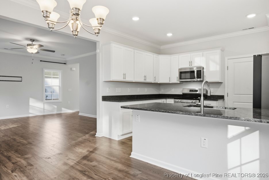 106 Knotts Berry Road Bunnlevel, NC 28323 - Photo 16 of 50 a kitchen with kitchen island granite countertop a sink cabinets and stainless steel appliances