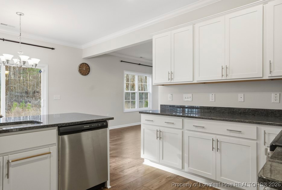106 Knotts Berry Road Bunnlevel, NC 28323 - Photo 20 of 50 a kitchen with granite countertop white cabinets and a black appliances