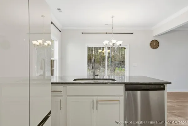 a kitchen with a refrigerator and a sink