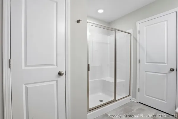 a bathroom with a glass shower door