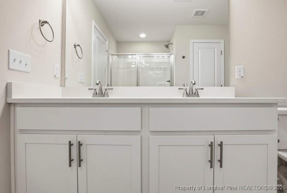 106 Knotts Berry Road Bunnlevel, NC 28323 - Photo 31 of 50 a bathroom with a double vanity sink and a mirror