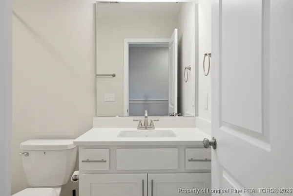 a bathroom with a sink toilet and vanity