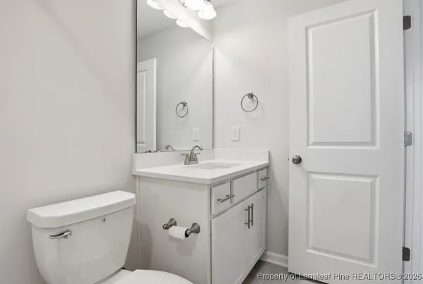 a bathroom with a sink toilet vanity and a mirror