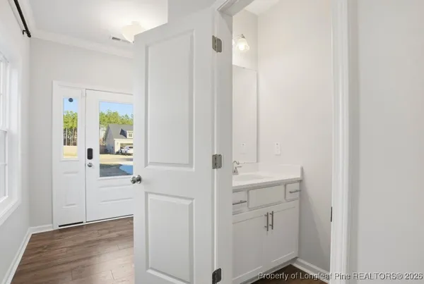 a view of walk in closet with white walls