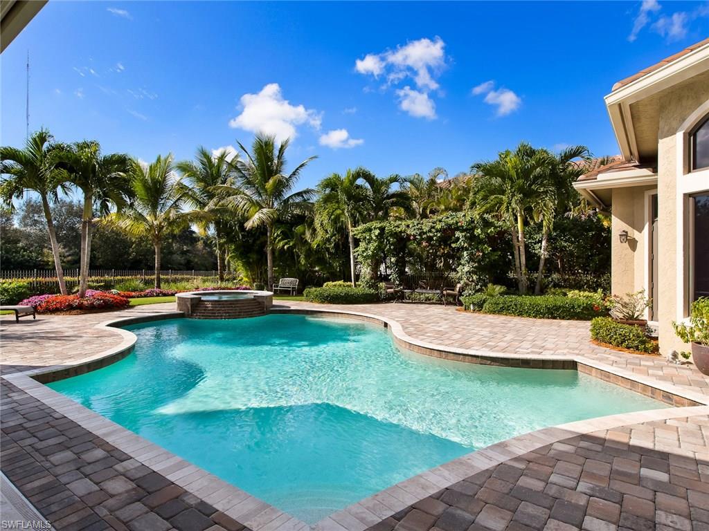 29170 Marcello Way Naples, FL 34110 - Photo 17 of 21 a view of a swimming pool with a lounge chairs