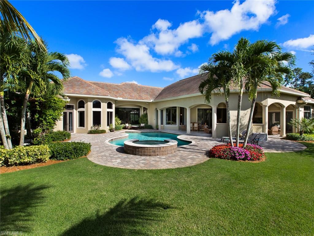 29170 Marcello Way Naples, FL 34110 - Photo 20 of 21 a front view of a house with a garden