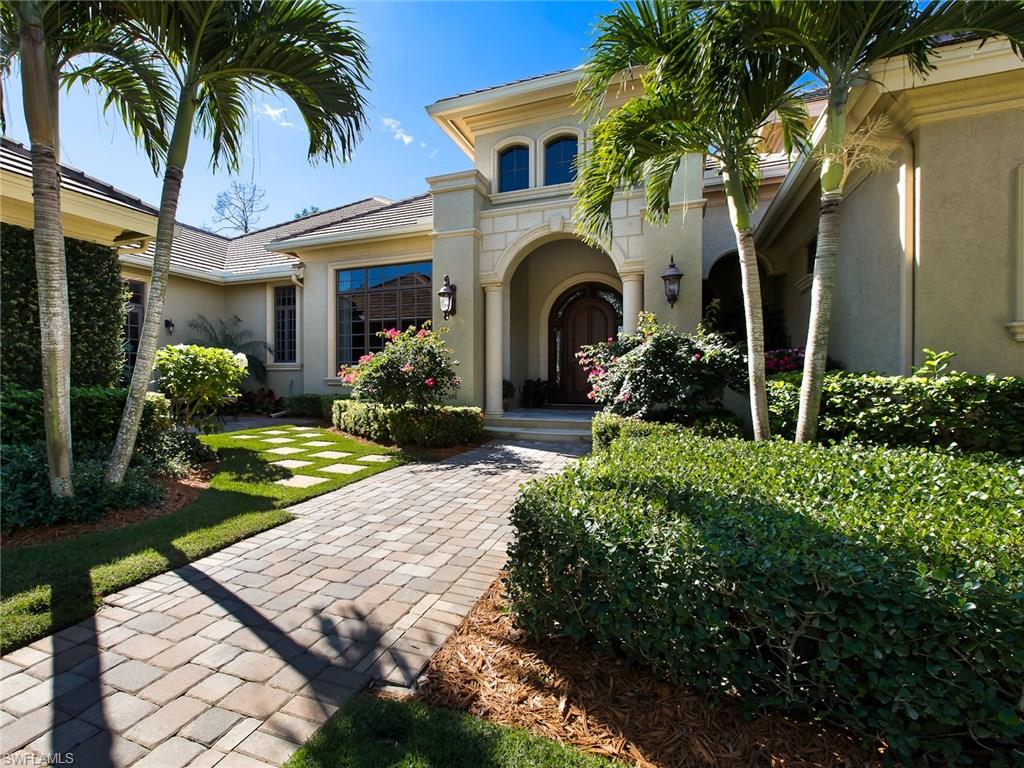 29170 Marcello Way Naples, FL 34110 - Photo 2 of 21 a front view of a house with garden and porch