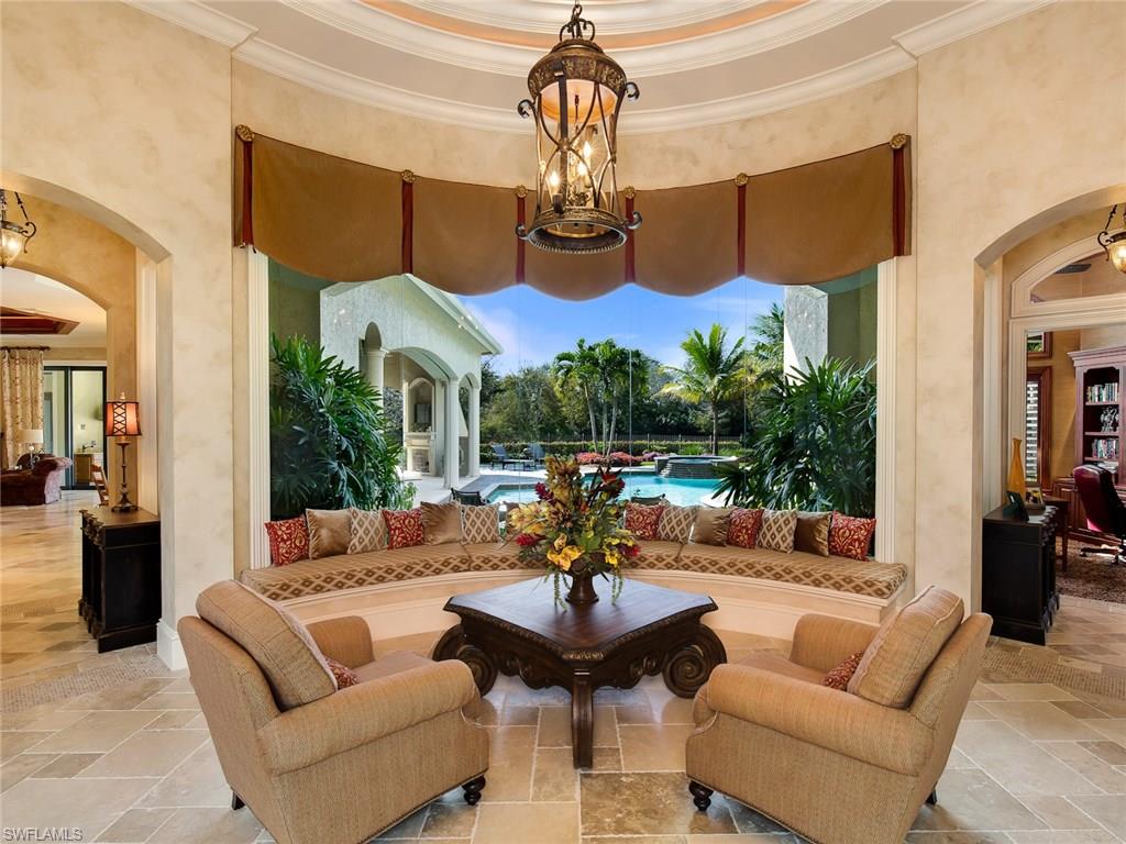29170 Marcello Way Naples, FL 34110 - Photo 3 of 21 a outdoor space with patio the couches and a fireplace with the potted plants