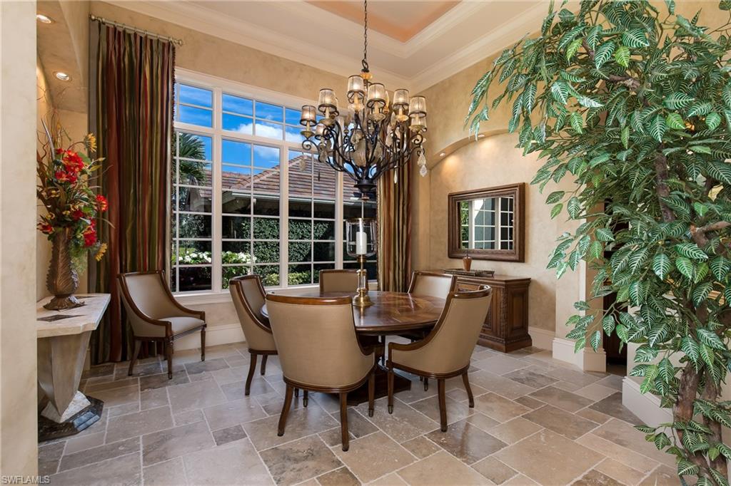 29170 Marcello Way Naples, FL 34110 - Photo 4 of 21 a view of a dining room with furniture and chandelier