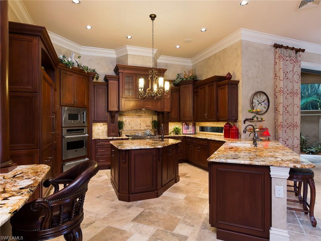 29170 Marcello Way Naples, FL 34110 - Photo 5 of 21 a kitchen with kitchen island granite countertop a sink stainless steel appliances and cabinets