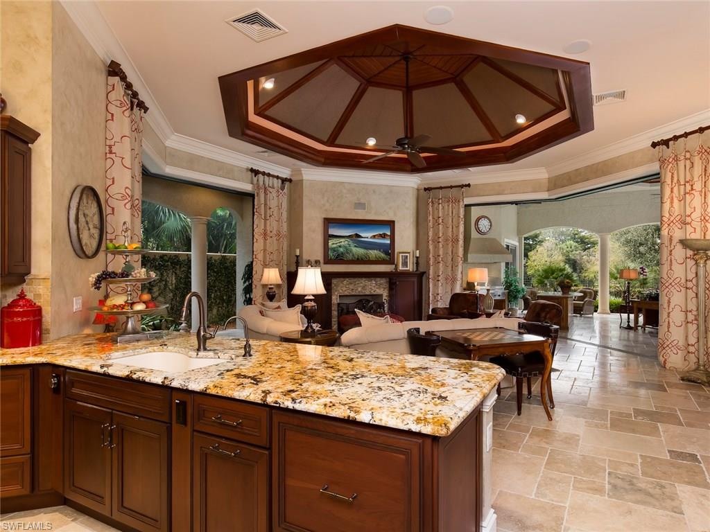 29170 Marcello Way Naples, FL 34110 - Photo 7 of 21 a kitchen with stainless steel appliances granite countertop a sink dishwasher and a dining table with wooden cabinet