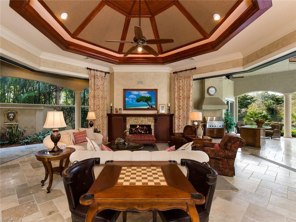 29170 Marcello Way Naples, FL 34110 - Photo 8 of 21 a living room with furniture a fireplace and a table