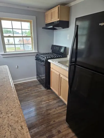 a kitchen with a refrigerator stove and cabinets