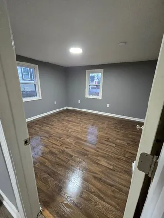 wooden floor in a hall with an empty room