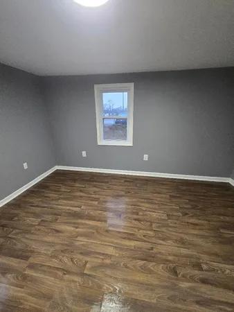 a view of room with wooden floor