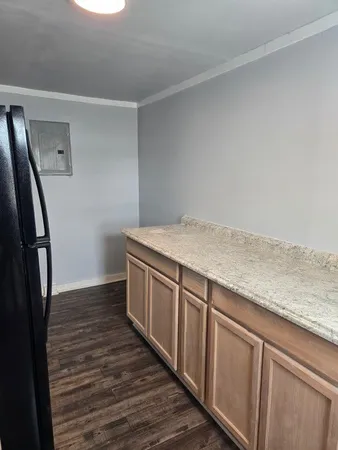 a view of a kitchen with sink and wooden floor
