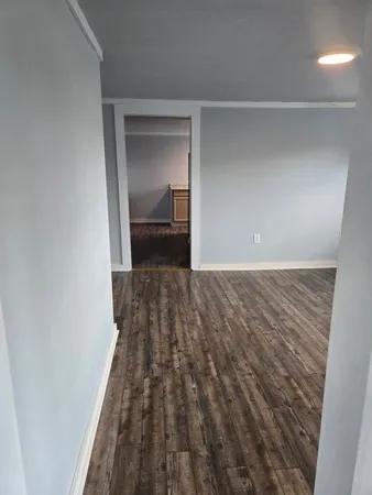 a view of a room with wooden floor