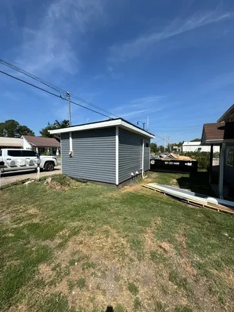 a view of a backyard with table and chairs