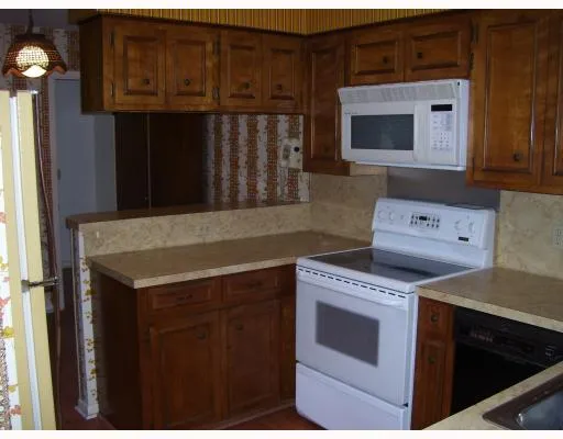 a kitchen with granite countertop a stove and a microwave