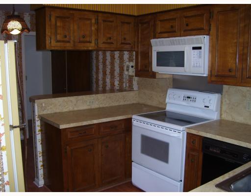 5417 Partridge Road Robstown, TX 78380 - Photo 3 of 5 a kitchen with granite countertop a stove and a microwave